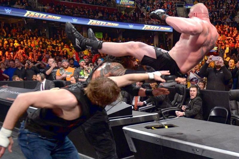 roman and dean hit power bomb to brock lesnar