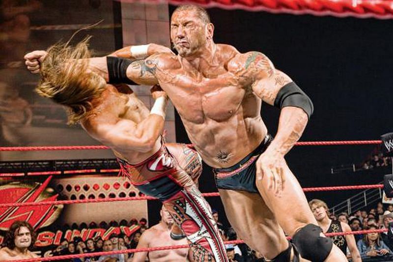 The Animal Batista floors Edge with a clothesline...or is it a lariat?