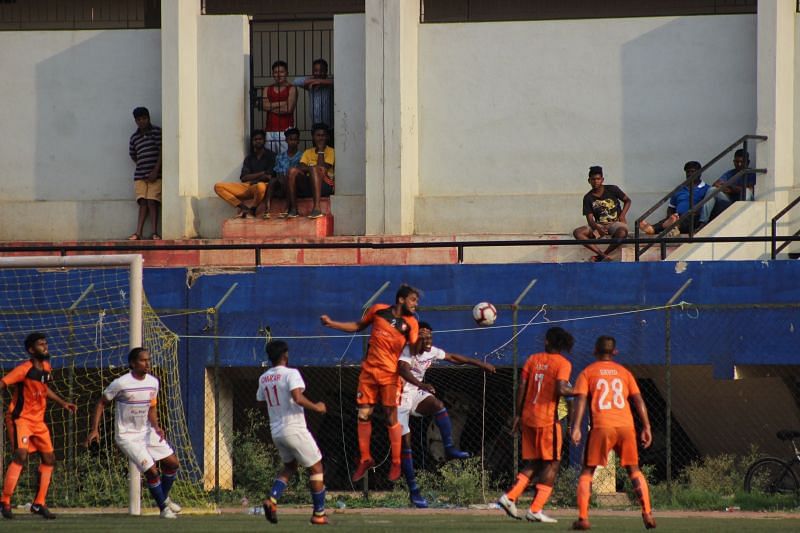 Both teams contest for the ball