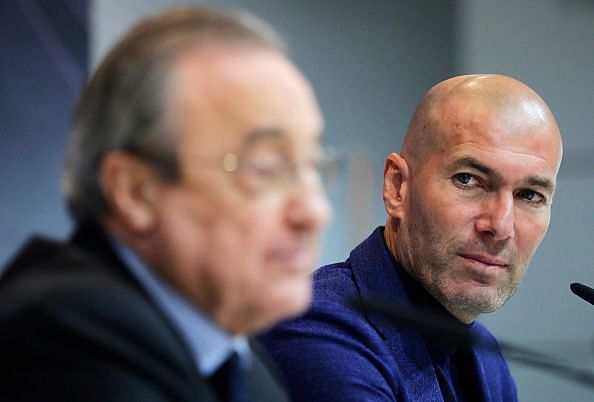 Zinedine Zidane looks on.
