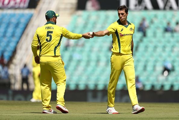 Pat Cummins receiving the game ball from Finch