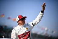 2007 Formula One World Champion Kimi Raikkonen waves at the crowd during the 2019 F1 Grand Prix of Australia