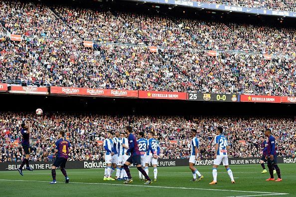 Messi watches his audacious free-kick as it floats goalwards to break the deadlock against Espanyol