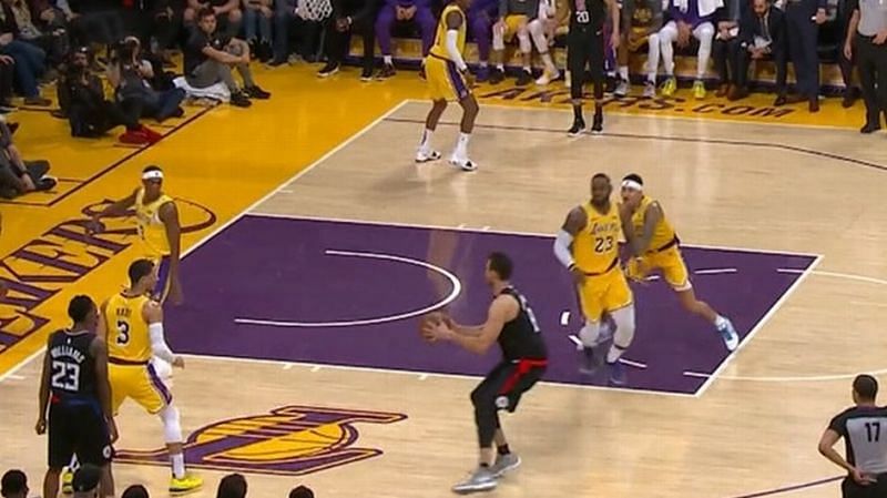 Kuzma shoves LeBron James (No. 23) to close the open shooter.