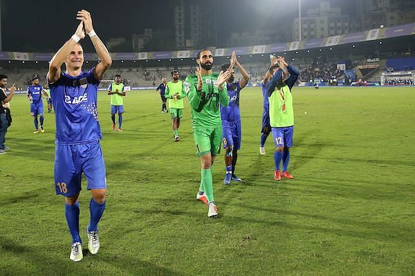 Mumbai City players Lucian Goian and Amrinder Singh celebrate after the team booked their berth in the ISL playoffs