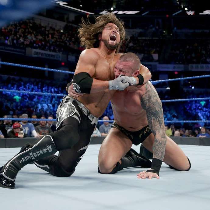 Randy Orton struggles in the grip of the Phenomenal AJ Styles.