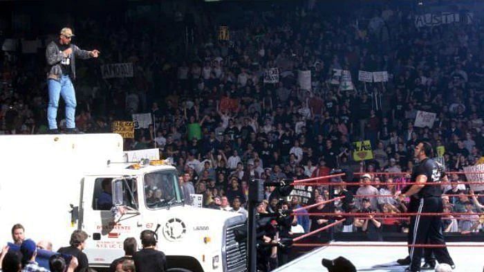 Stone Cold on top of a beer truck before spraying The Rock and The McMah