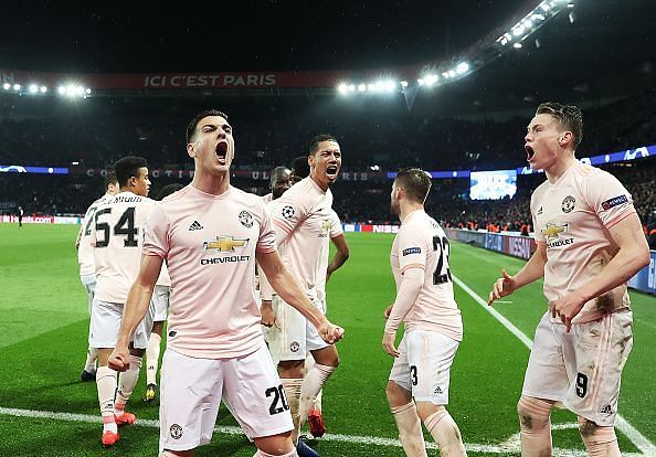 Manchester United players celebrating with the fans after their historic victory against PSG in the Champions League