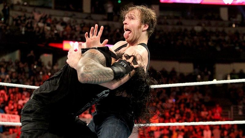 Dean Ambrose hitting a dirty deeds on Roman Reigns.