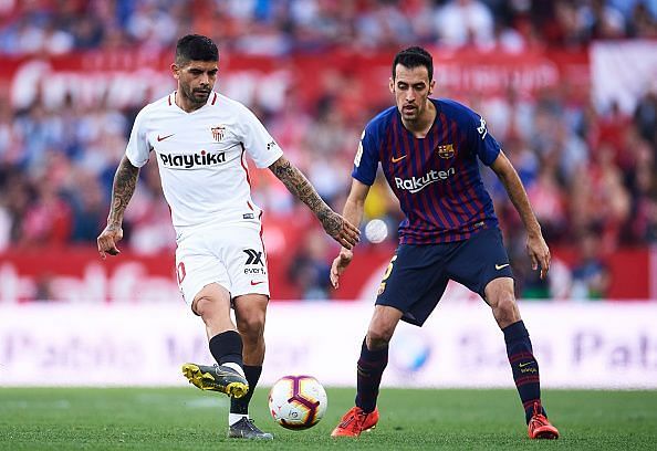 Banega battling with Busquets for possession during a recent league fixture between the pair