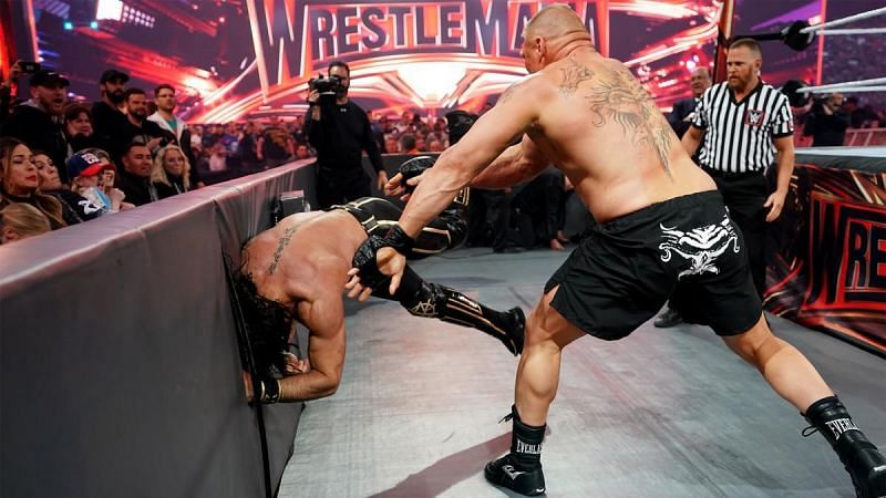 Brock Lesnar throws Seth Rollins into the barricades