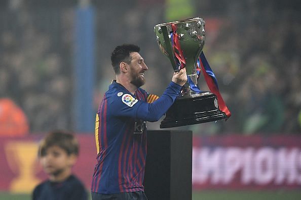 Lionel Messi lifts the La Liga trophy after a 1-0 win over Levante.