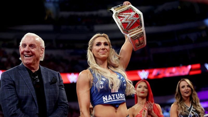 Charlotte Flair posing with the Raw Women&#039;s Title following her triumph