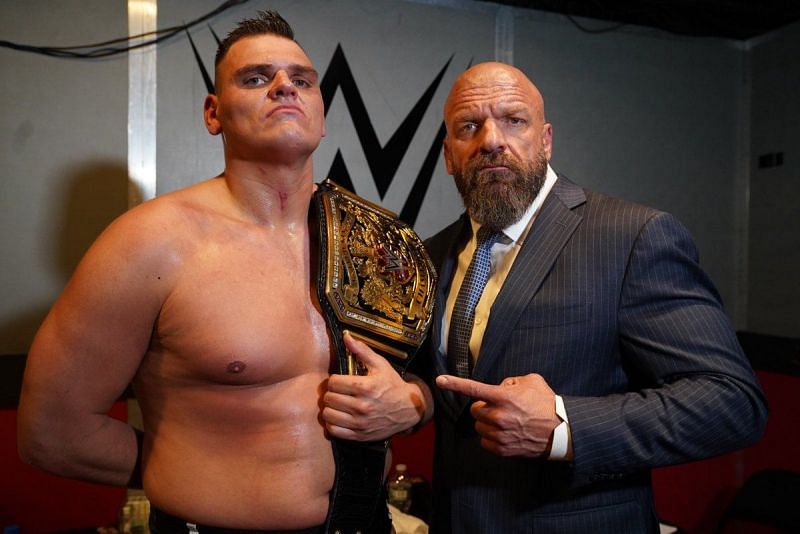 NEW NXT UK Champion WALTER posing with Triple H