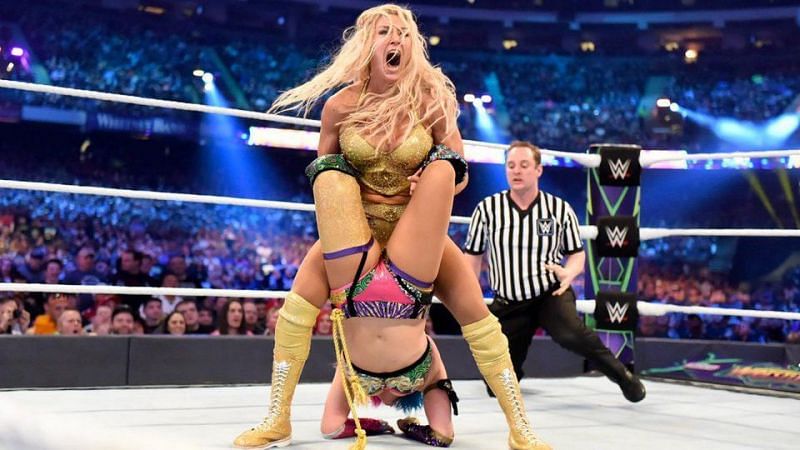 Charlotte locking in a submission move on Asuka