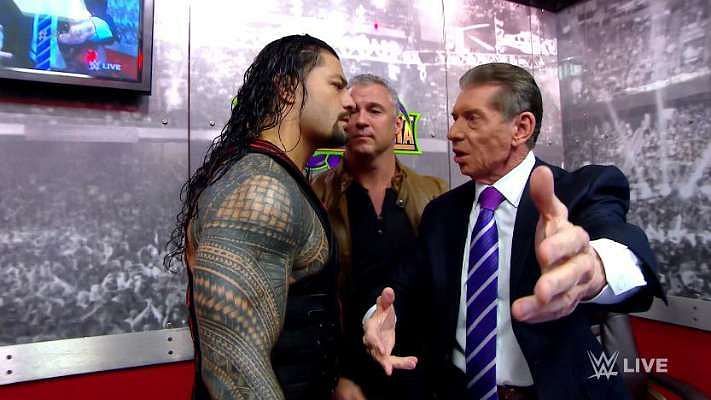 Roman Reigns with Shane and Vince McMahon