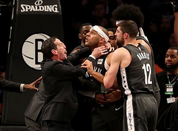 Jared D&#039;Angelo Russell Joel Embiid and Jarrett Allen scampering for the ball Dudley being held back after the 3rd quarter scuffle