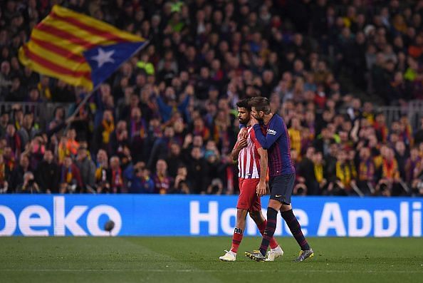 Costa is consoled by compatriot Pique after receiving a straight red card for dissent