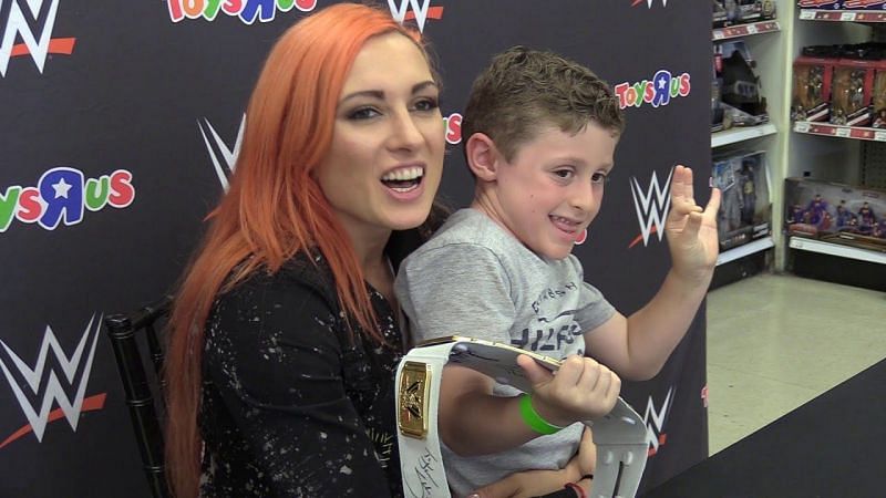 Becky Lynch with a young male fan. Lynch&#039;s popularity transcends age, race, and gender.