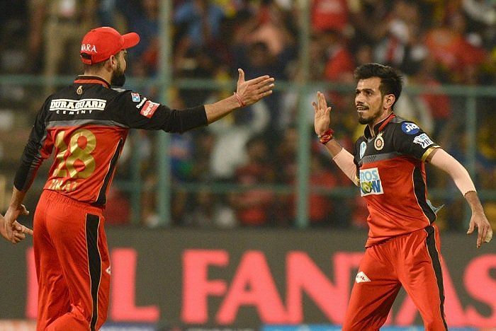 Chahal and Kohli after picking up a wicket (Picture Courtesy-BCCI/iplt20.com)