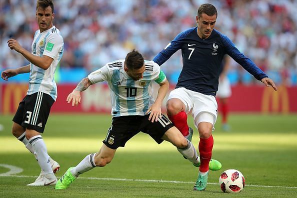Lionel Messi battles with Antoine Griezmann for the ball