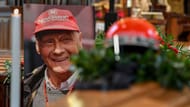 Lauda's famous red race helmet was placed above his coffin