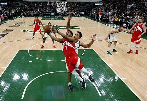 Toronto Raptors' Kyle Lowry in action against Malcolm Brogdon and the Milwaukee Bucks in Game Five