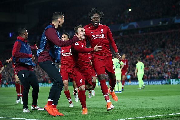 Origi wheels away to celebrate his winning goal with teammates as Liverpool stunned Barca 4-0