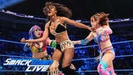 Asuka and Kairi Sane double team a local competitor (WWE's term for unnamed enhancement talent.)