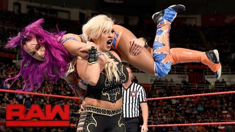 Dana Brooke hefts Sasha Banks onto her shoulders.