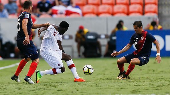 Alphonso Davies in action for Canada (middle)