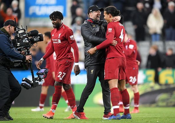 Klopp embraces van Dijk and Origi after their dramatic away win