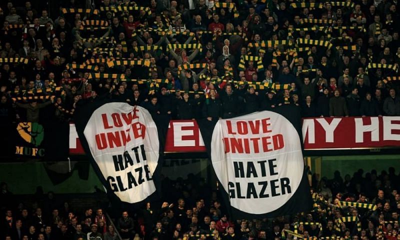 Anti-Glazer banners dangling over the stands at Old Trafford.