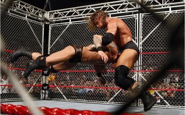 Triple H delivers a Pedigree to The Rock in Hell in a Cell.