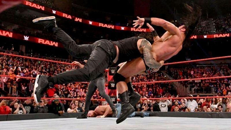 Roman Reigns spears Drew McIntyre out of his boots on an episode of RAW