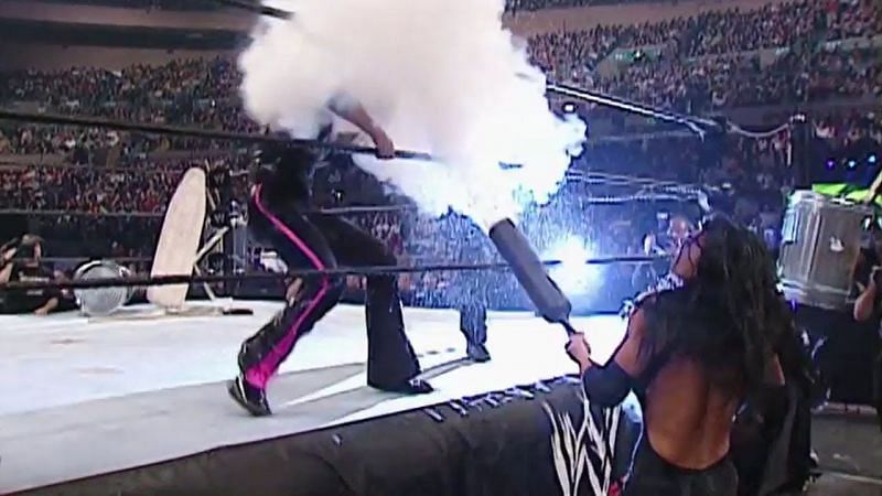 Obscured behind a cloud of CO2 gas is Trish Stratus. Victoria wields the fire extinguisher