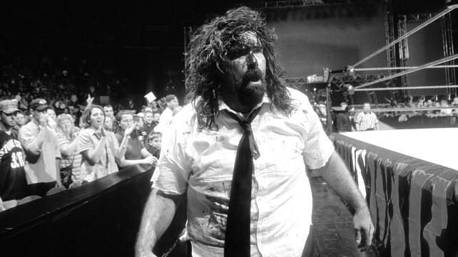 A bloody Mankind limps away from the ring.