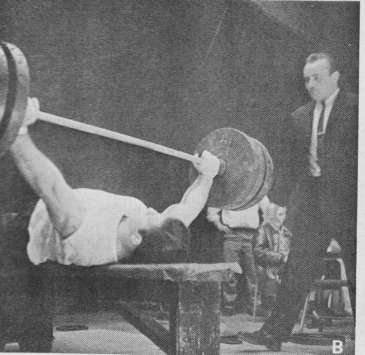 A young Bruno Sammartino attempting a massive bench press.