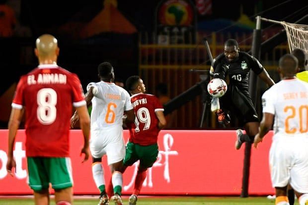 The Ivorian keeper makes a clearance.
