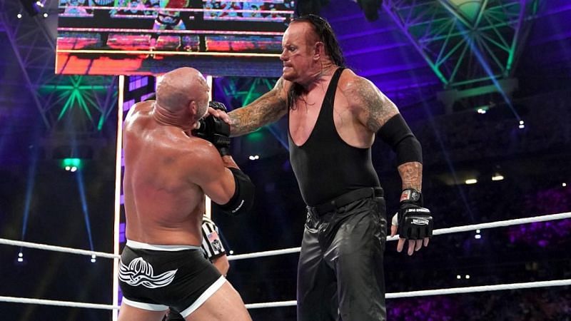 The Undertaker proceeds to choke out Goldberg during their 
