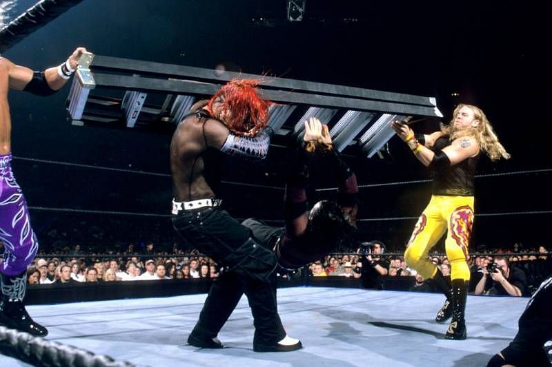 Edge and Christian take out Jeff Hardy with a double team ladder attack at TLC II.