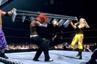 Edge and Christian take out Jeff Hardy with a double team ladder attack at TLC II.