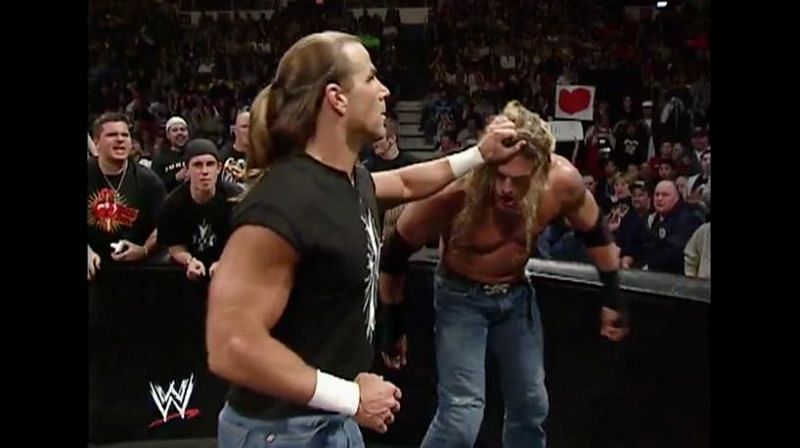 HBK measures Edge for a brutal closed fist blow.