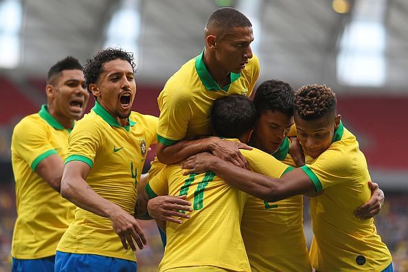 Brazil team-members celebrate after Coutinho made it 3-0
