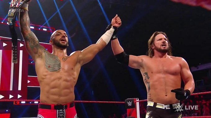 AJ Styles raises the hand of WWE United States Champion Ricochet after an epic dream match on Monday Night RAW.