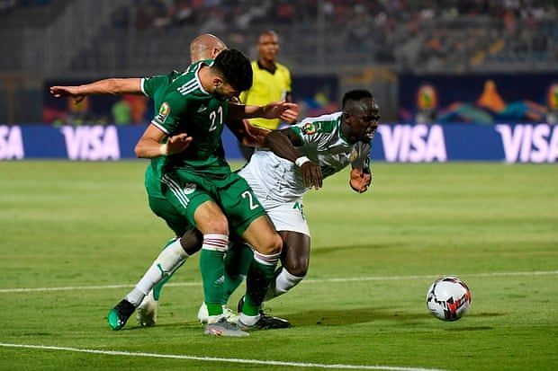 Algeria&acirc;s Ramy Bensebaini and Adlene Guedioura sandwiched Sadio Mane for a combined tackle.