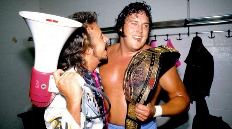 Jimmy Hart and Honky Tonk Man celebrate backstage.