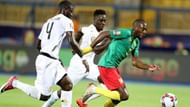 Cameroon's Toko Ekambi (r), attempting to break away from Ghana's hawk-eyed defenders