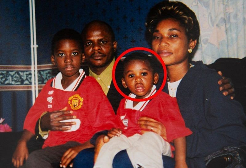 Baby Aaron Wan-Bissaka on his mother&#039;s knee in his Man Utd shirt Credit: Jamie McPhilimey - The Sun