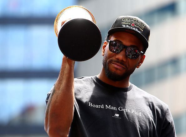 Kawhi celebrates with his Finals MVP trophy during the Raptors victory parade on Monday